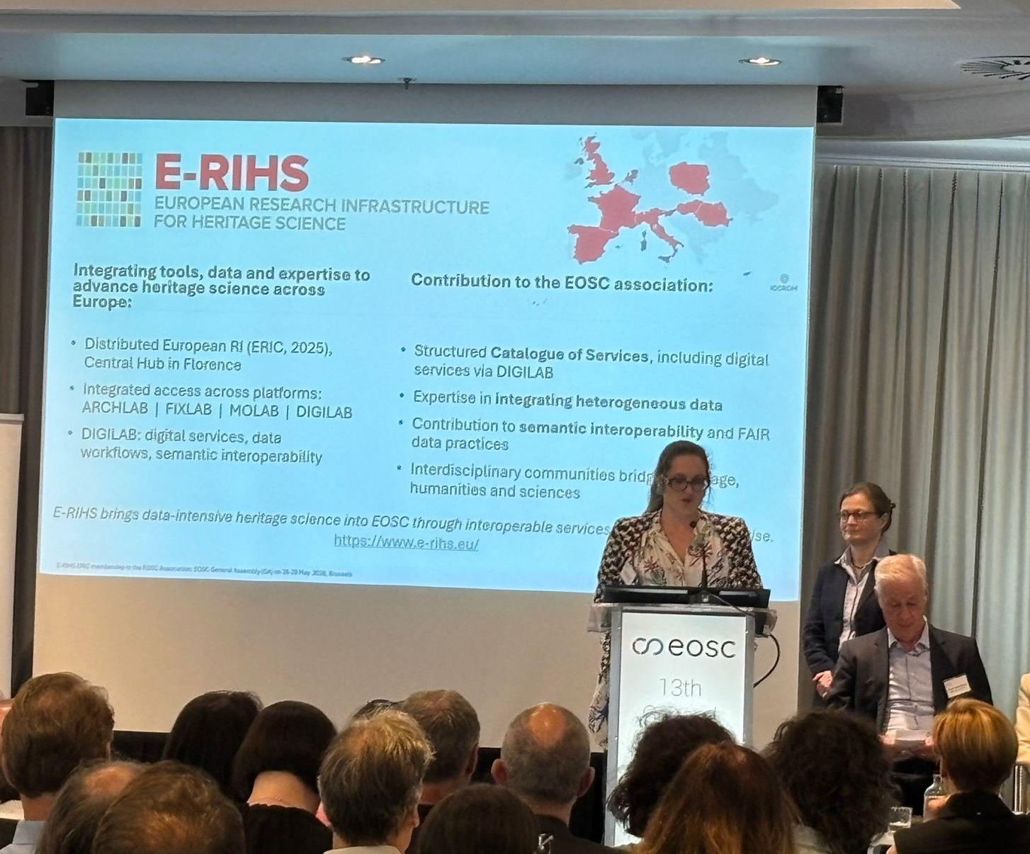 Photo from the EOSC General Assembly on May 2026. Many people captured from the back listening Anaïs Guillem presenting E-RIHS