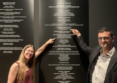 Emilio Cano, exhibition curator and E-RIHS Spanish National Node Coordinator, and Blanca Ramírez Barat, curatorial support, both CENIM-CSIC, at the credits wall of “Misterios de la materia” MAN, Madrid.
