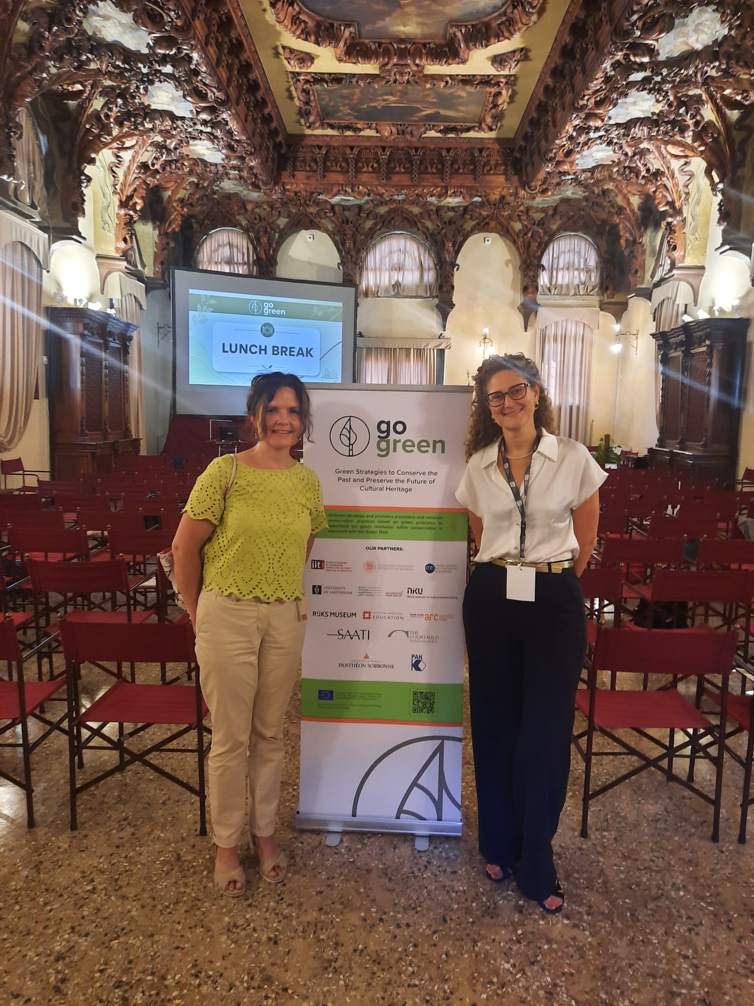 Polonca Ropret and Katrien Keune, standing next to the GoGreen final event poster, Venice.